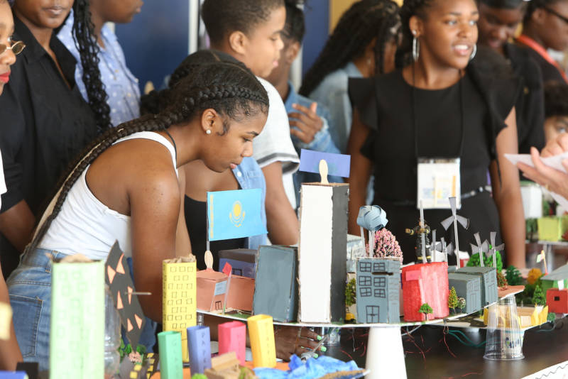 Students at a science fair display table