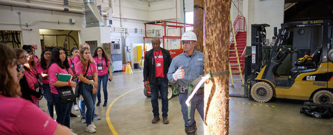 Technician demonstrating climbing a telephone pole