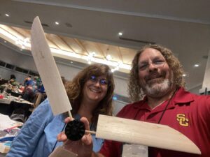 Two teachers holding small wind turbine blades